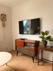 a living room with a flat screen tv on a table at Guesthouse Leon - Historic Home Near City Center with Free Parking in Tórshavn