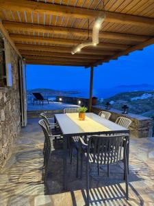 a table and chairs on a patio with a view at To Petrino Serifos in Livadakia