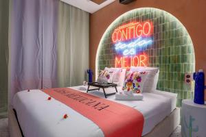 a room with a bed with a neon sign on it at La Casa Mexicana in Alfortville