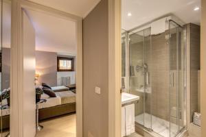 a bathroom with a shower and a sink and a tub at HiSuiteROME - ApartHotel in Rome +84 photos