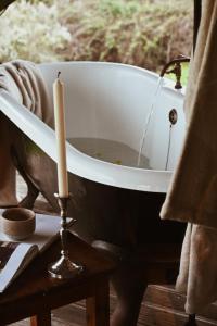an old bath tub with a candle on a table at Fazenda Azul in Budens