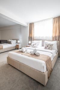 two large beds in a bedroom with a large window at Oban Suites Istanbul in Istanbul