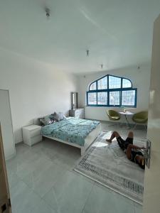 a person laying on the floor in a bedroom at Vi Home Stay Corniche in Abu Dhabi