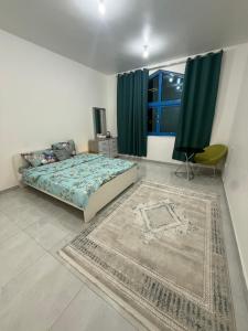 a bedroom with a bed and a couch and a window at Vi Home Stay Corniche in Abu Dhabi +11 photos