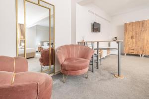 a room with a chair and a table and a mirror at Oban Suites Istanbul in Istanbul
