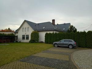 a car parked in front of a house at Apartamenty Sokółka II in Sokółka
