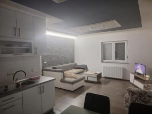 a living room with a couch and a table at Apartman Knežević in Donja Varoš