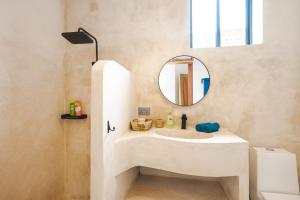 a bathroom with a sink and a mirror at Nishati - Private Beach Villa in Matemwe +27 photos