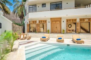 a villa with a swimming pool and a house at Nishati - Private Beach Villa in Matemwe