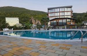 a large swimming pool in front of a building at SANI Apartments by Kanevce in Ohrid