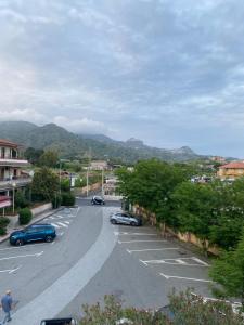 a street with cars parked in a parking lot at La mia casetta in Taormina
