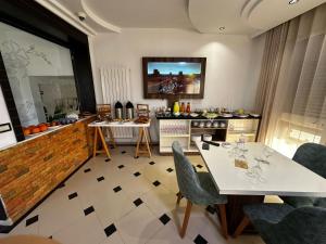 a living room with a table and chairs at Impavid Hotel in Gabès