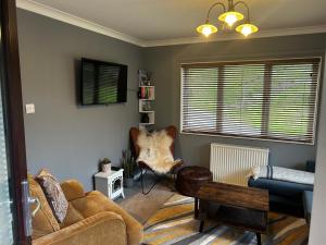 a living room with a couch and a table at 22 Two Little Ducks in Lynton