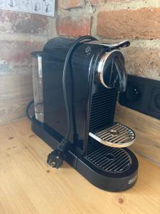 a black toaster sitting on top of a table at Apartmán u Ondrika in Spišské Tomášovce