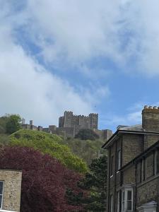 a castle on top of a hill with houses at St Marys Cottage 2 in Dover
