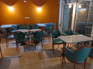 a row of tables and chairs in a restaurant at Hotel BETHEL in Nevers