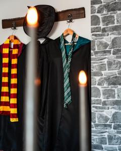 a black shirt and a tie hanging on a wall at Wizard's apartment Plovdiv in Plovdiv