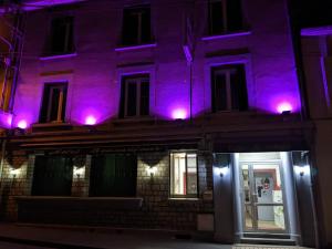 a purple building with purple lights on it at Hotel BETHEL in Nevers