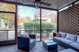 a screened in porch with a couch and chairs at Alpine Studio in Helen