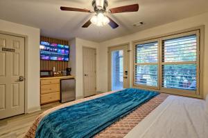 a bedroom with a large bed with a ceiling fan at Alpine Studio in Helen