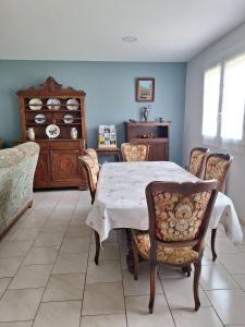 a dining room with a table and chairs at Au gîte de Marcelle in Labergement-lès-Seurre