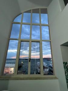 a large window with a view of the water at Casa MiraMare in Procida