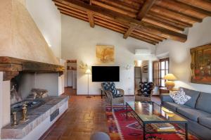 a living room with a couch and a fireplace at Fattoria La Striscia in Gambassi Terme