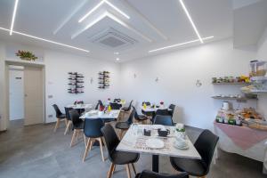 a restaurant with tables and chairs in a room at Villavità in Agerola