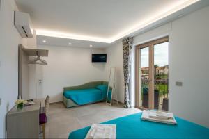 a living room with a blue couch and a window at Villavità in Agerola +73 photos