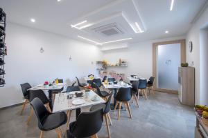 a dining room with tables and chairs and a refrigerator at Villavità in Agerola