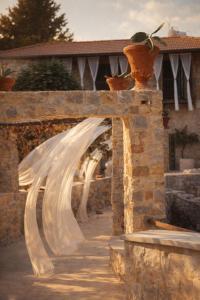 a wedding veil is hanging over a stone bridge at Boreas Retreat - Mountain Escape & Spa in Batroûn