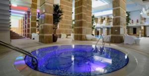 a jacuzzi tub in the middle of a building at Apartament Maya luxury in Bucharest