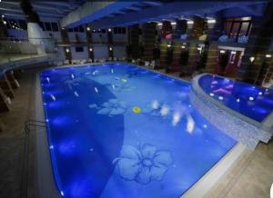 a large blue pool with flowers painted on it at Apartament Maya luxury in Bucharest +15 photos