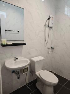 a white bathroom with a toilet and a sink at แวะมาพักโคกกลอย Wae Ma Phak Khokkoi in Ban Huai Sai +22 photos