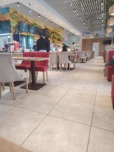 a dining room with tables and chairs in a restaurant at Apartament Maya luxury in Bucharest