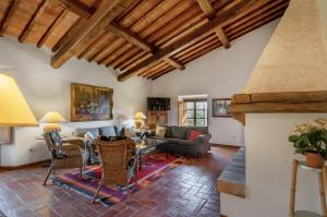 a living room with a couch and a table and chairs at Fattoria La Striscia in Gambassi Terme