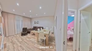 a living room with a table and a couch at Apartamentos Bemar in Chipiona