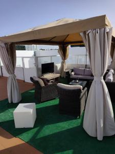 a living room with chairs and a tent at Apartamentos Bemar in Chipiona