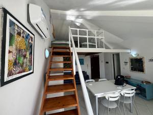 a room with a bunk bed and a table and chairs at Holiday Properties, Ilha do Fogo in Santa Maria