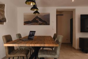 a dining room table with a laptop on top of it at Chalet Ferienwohnung zwischen Berchtesgaden und Ramsau in Bischofswiesen +13 photos