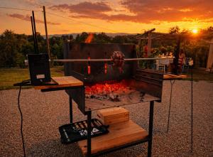 a grill with a fire in it with a laptop at Agriturismo Podere Sant' Agnese - Suite Apartment in Bibbiena