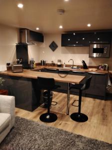a kitchen with a table and a counter top at south view farm cottage 1 Bed in Bradford