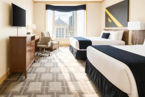 a hotel room with two beds and a window at The Buckingham Hotel in Chicago +33 photos
