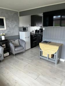 a kitchen with a table in the middle of it at JJ chalet in Scratby