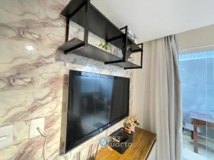 a large flat screen tv hanging on a wall at Samburá Residece By 123Quarto in Camalaú