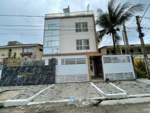 a house with two garage doors in front of it at Samburá Residece By 123Quarto in Camalaú