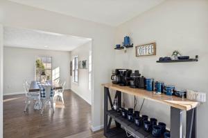 a kitchen and dining room with a table with a coffee maker at Spacious 4 bd with hottub, theater & game zone in Union Grove
