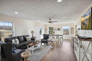 a living room with a couch and a table at Spacious 4 bd with hottub, theater & game zone in Union Grove