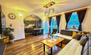 a living room with a couch and a table at Holiday home Melani - with private heated pool and sauna in Sinac