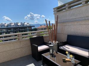 a balcony with two couches and a table on a building at CANELAS CLASS con AMPLIAS TERRAZAS in Portonovo +120 photos